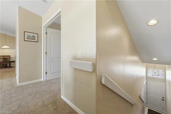 Hall featuring recessed lighting, light carpet, and an upstairs landing