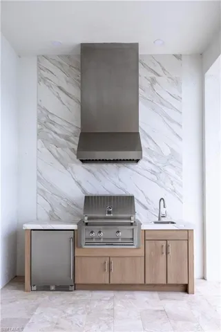 View of patio / terrace featuring exterior kitchen and a sink