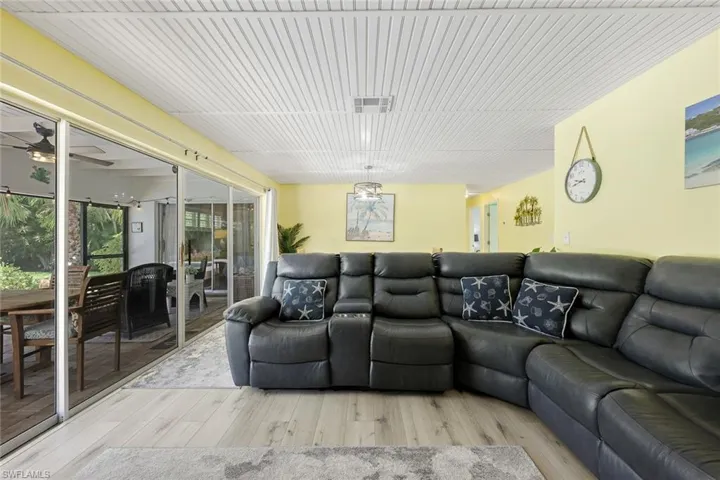 Living room with ceiling fan and light hardwood / wood-style flooring
