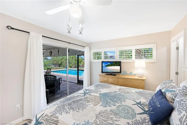 Bedroom featuring ceiling fan and access to exterior