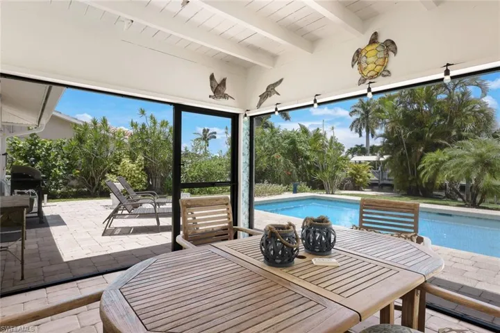 View of swimming pool with a patio area and grilling area