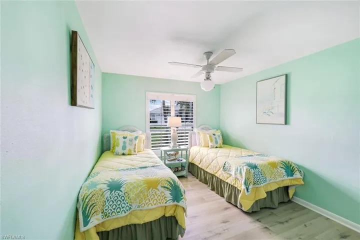 Bedroom featuring hardwood / wood-style flooring and ceiling fan