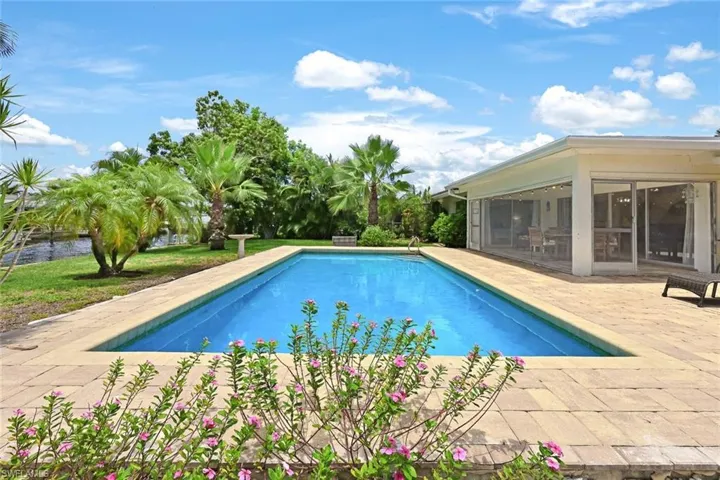 View of pool featuring a patio and a sunroom