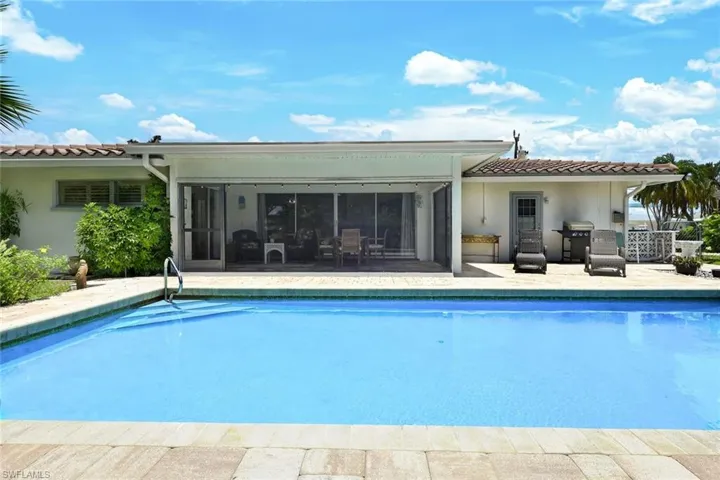 View of swimming pool featuring grilling area and a patio