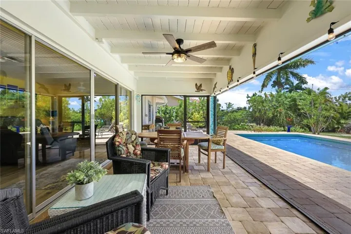 View of terrace with an outdoor hangout area and ceiling fan