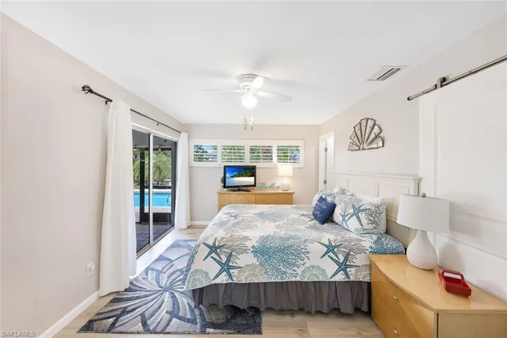Bedroom featuring light hardwood / wood-style flooring, ceiling fan, and access to outside
