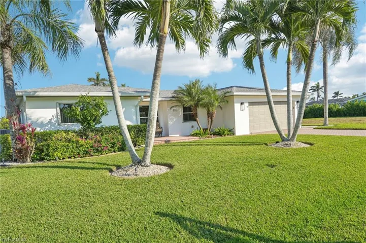 Ranch-style home with a garage and a front yard