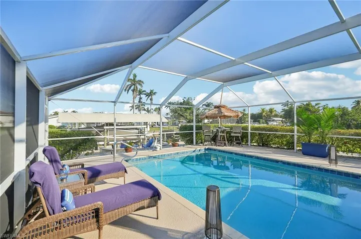 View of swimming pool featuring a lanai and a patio