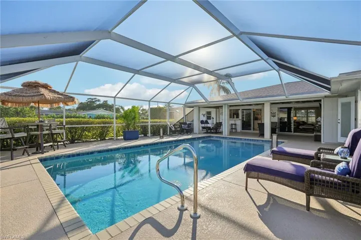 View of pool with a lanai and a patio area