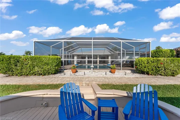 Back of house featuring a patio and glass enclosure