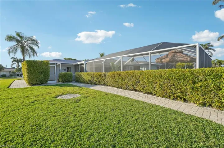 View of yard with glass enclosure