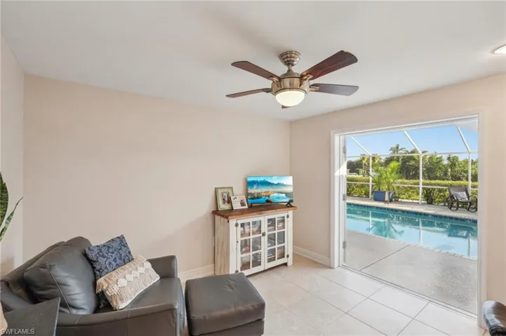 Sitting room featuring ceiling fan and light tile patterned floors