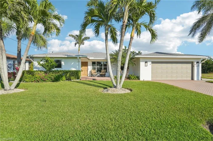 Ranch-style home with a garage and a front yard