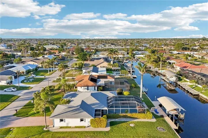 Birds eye view of property with a water view