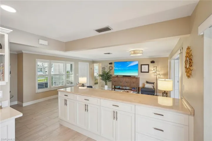 Kitchen featuring ornamental molding, white cabinets, and light hardwood / wood-style floors