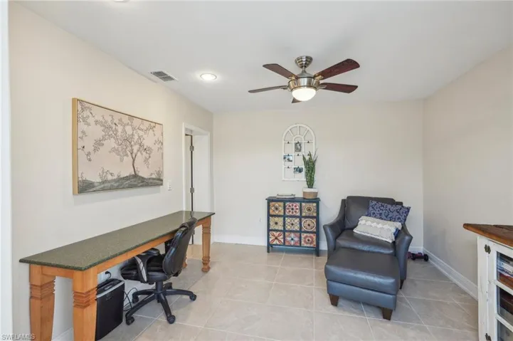 Tiled office featuring ceiling fan