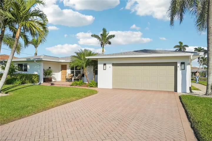 Ranch-style home featuring a garage and a front yard