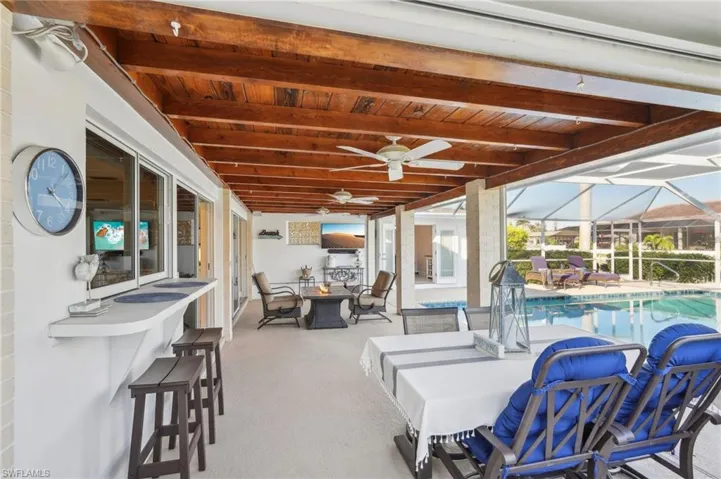 View of patio / terrace featuring exterior bar and a fire pit