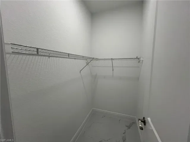Walk in closet 2 featuring marble flooring
