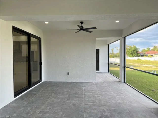 Unfurnished sunroom featuring ceiling fan