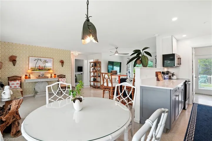 Dining space featuring wallpapered walls, recessed lighting, and ceiling fan