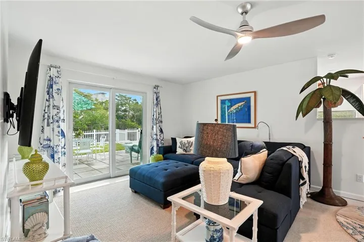 Living area featuring carpet floors and ceiling fan