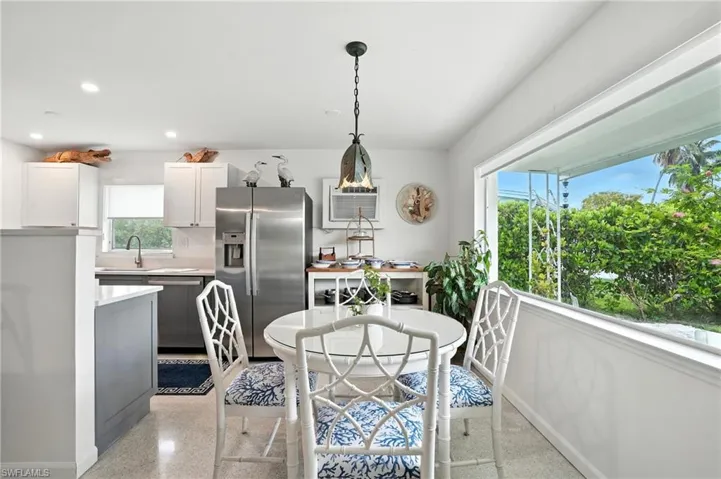 Dining space featuring recessed lighting and dark aggregate flooring
