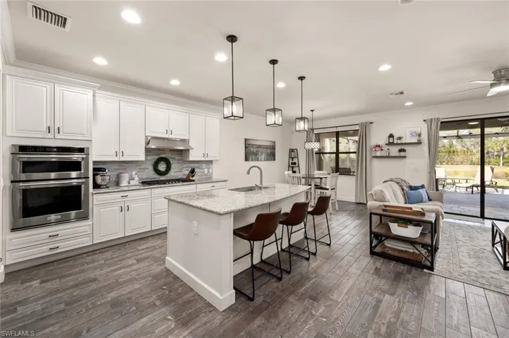 molding, a sink, under cabinet range hood, and double oven