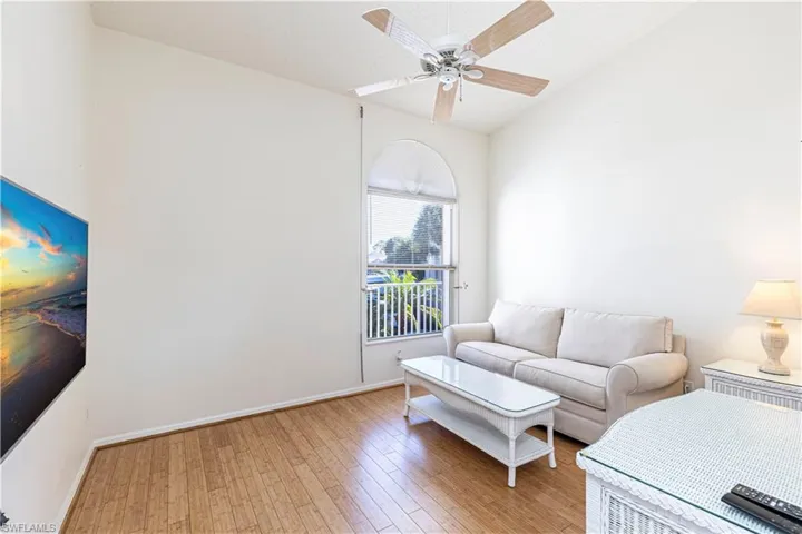 Guest bedroom w/ light wood-style flooring & ceiling fan.
