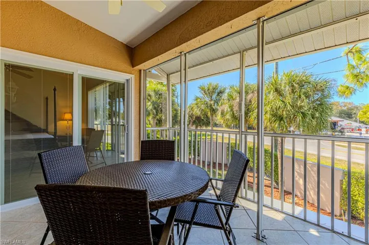 Screened patio w/ balcony, outdoor dining area & ceiling fan.