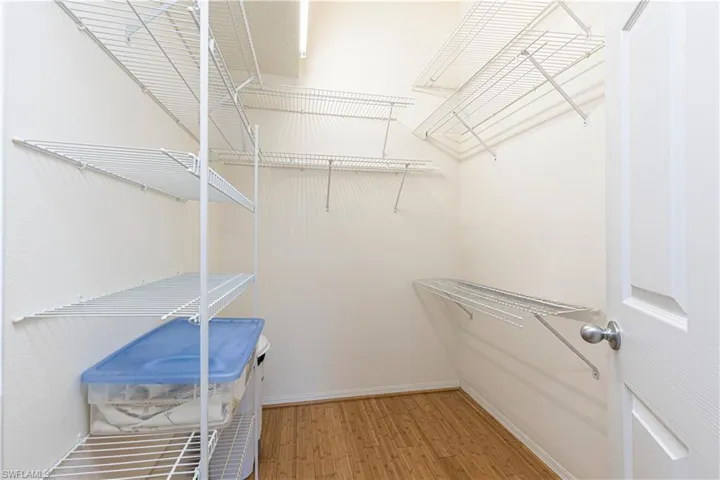Walk-in closet featuring light wood-style floors.