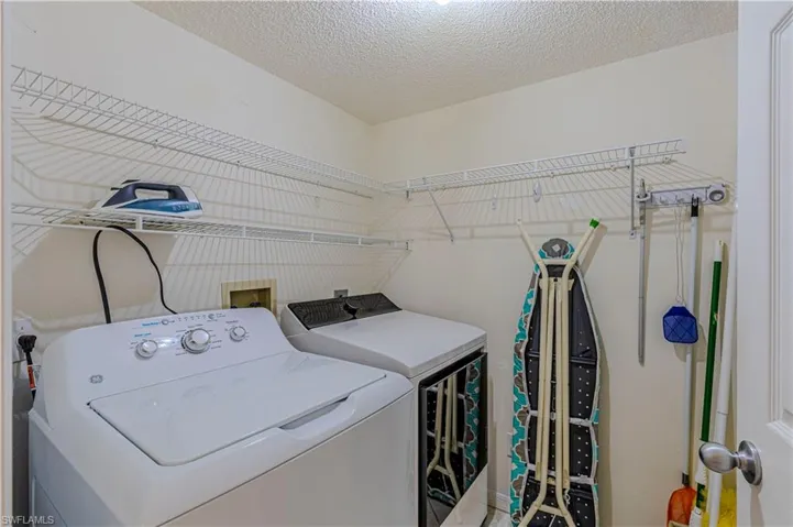 Laundry area featuring washing machine and dryer & storage.