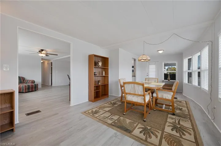 Dining room with light hardwood / wood-style floors and ceiling fan