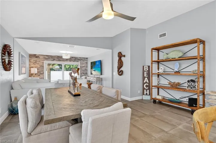 Dining room featuring vaulted ceiling and ceiling fan