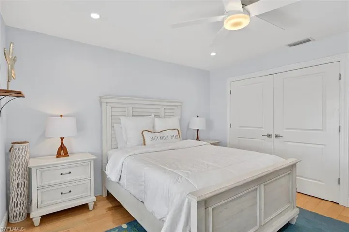 Bedroom with a ceiling fan, recessed lighting, light wood finished floors, and a closet
