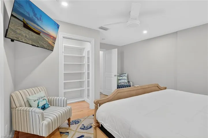 Bedroom with wood finished floors, ceiling fan, and recessed lighting