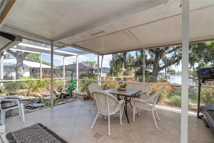This waterfront screened lanai is vast at 26' x 13', with a small koi pond