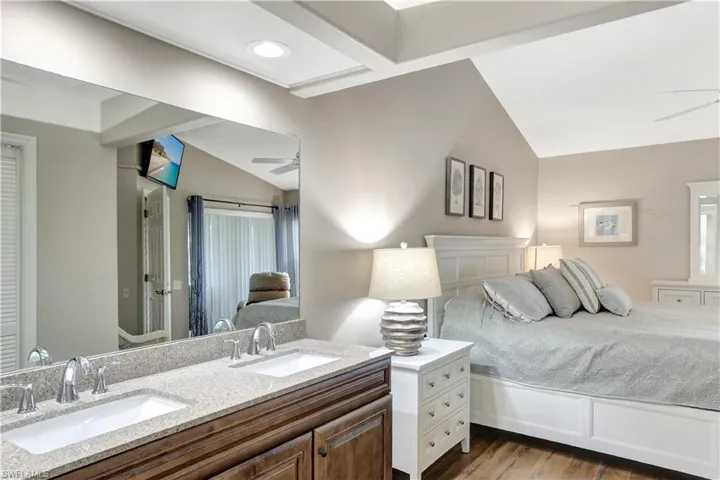 Bedroom featuring lofted ceiling and wood finished floors