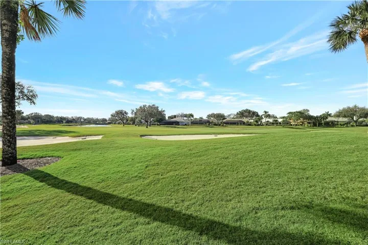 View of property's community featuring view of golf course and a lawn