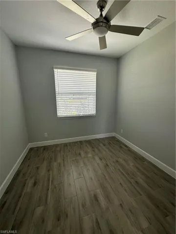 Unfurnished room featuring wood finish floors and ceiling fan