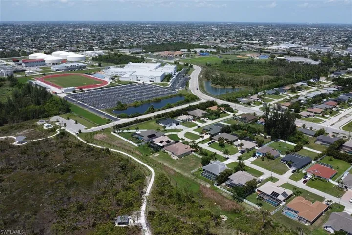 Aerial view of the property's backyard, nature preserve Joe Coviello Park, and high school Ida S. Baker