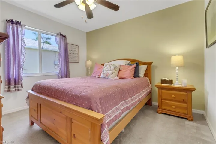 Bedroom featuring carpet floors and baseboards