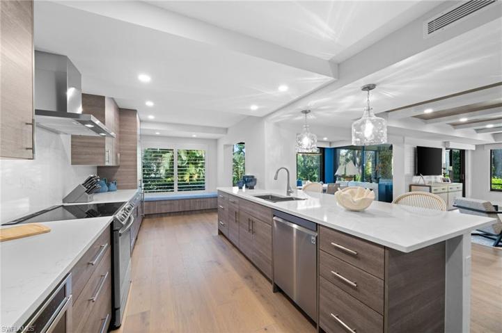 Selective Kitchen blends White Quartz with Wood and Stainless to create a chic Uptown ambiance