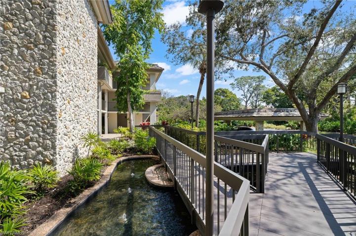 Cross the bridge beside the bubbling ponds to this modern upscale condo