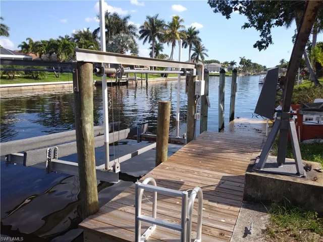 Dock with boat lift and a water view
