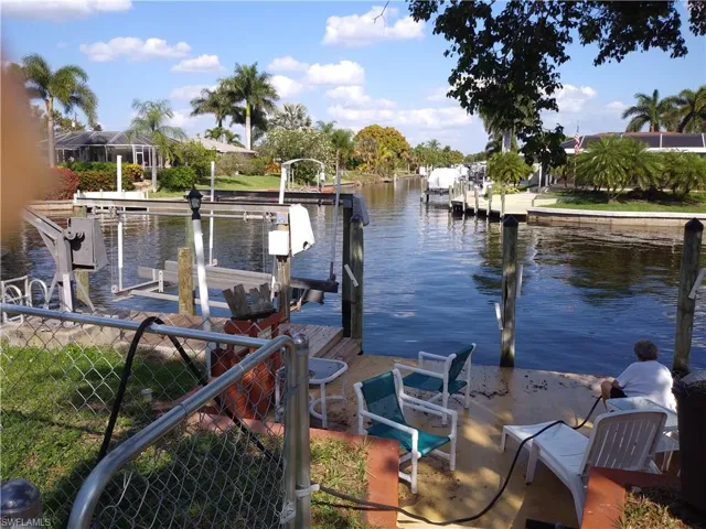 Dock area with a water view and boat lift