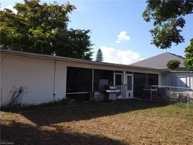 Rear view of house featuring a sunroom