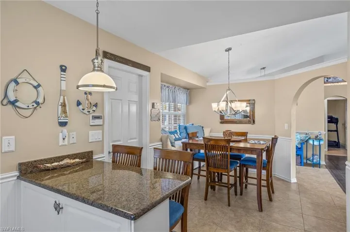 10681- Enjoy coffee at the breakfast bar or sit down at the table in this bright cheery kitchen