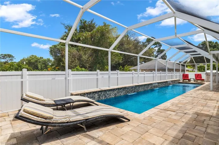 shared backyard pool with separate lounge area. Outdoor kitchen on 10689 side.