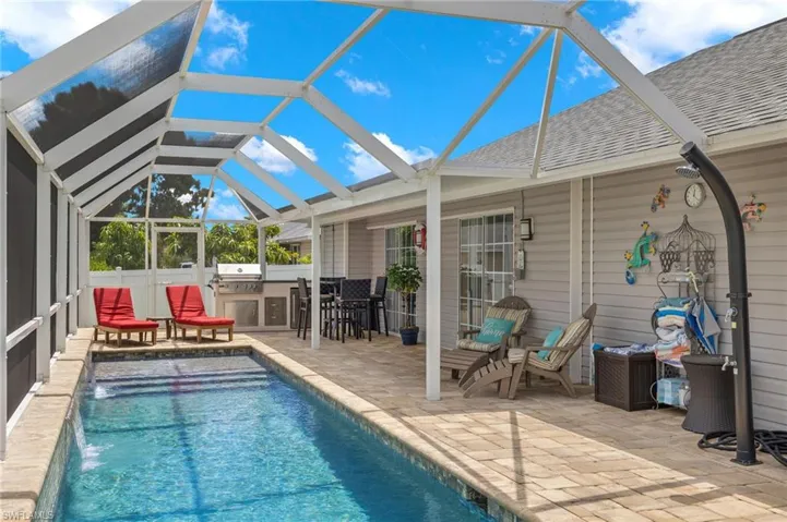 Facing the 10689 side with outdoor kitchen and walkout from family room and primary bedroom with outdoor shower